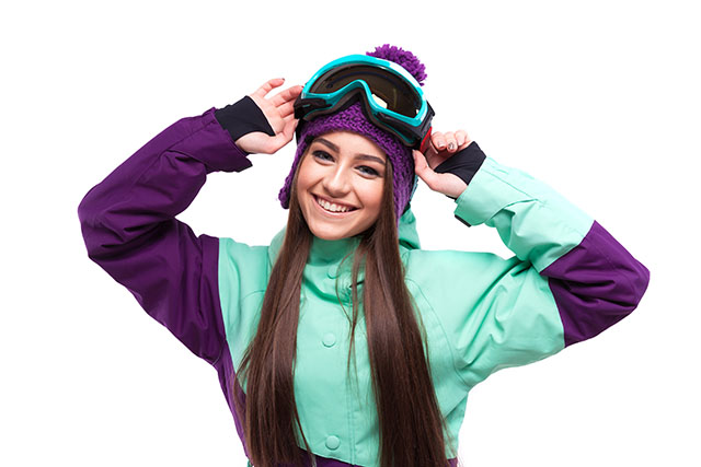 young woman in purple ski outfit