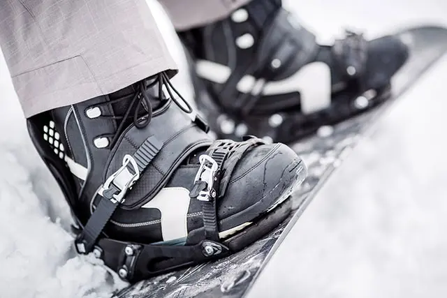 man sitting on the snow with snowboard